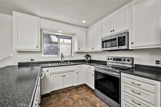 19650 Mountain Mdw N, Hidden Valley Lake, CA 95467 - kitchen featuring stainless steel appliances, dark countertops, white cabinetry, stone finish flooring, and recessed lighting