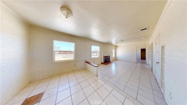 21845 Fox Ave, Apple Valley, CA 92307 - empty room featuring light tile patterned floors and a fireplace