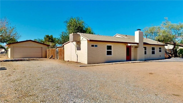 21845 Fox Ave, Apple Valley, CA 92307 - view of front of property featuring a chimney, a detached garage, a tile roof, and an outdoor structure