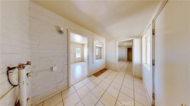 21845 Fox Ave, Apple Valley, CA 92307 - corridor featuring light tile patterned floors and a textured ceiling