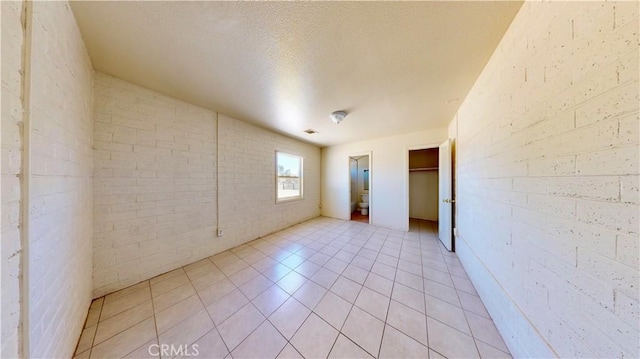 21845 Fox Ave, Apple Valley, CA 92307 - unfurnished room with light tile patterned flooring and a textured ceiling