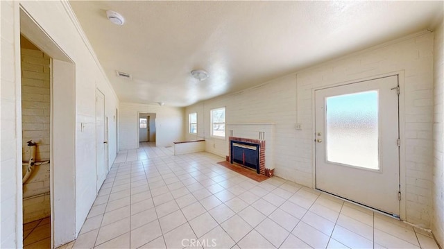 21845 Fox Ave, Apple Valley, CA 92307 - unfurnished living room featuring a brick fireplace and light tile patterned floors