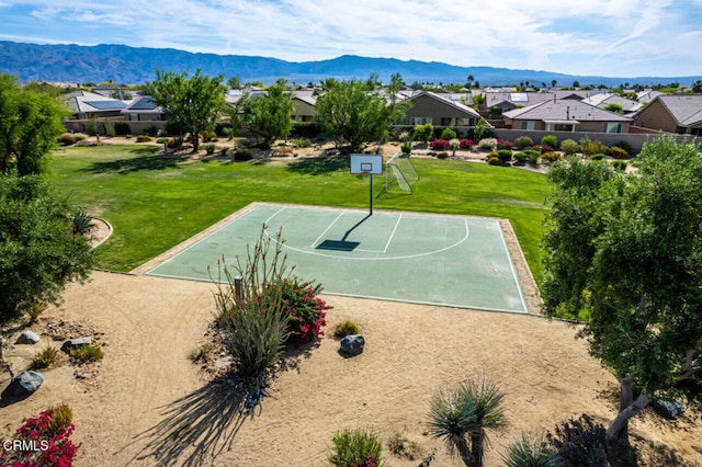 84319 Cigno Ct, Indio, CA 92203 - view of sport court featuring community basketball court, a lawn, a residential view, and a mountain view