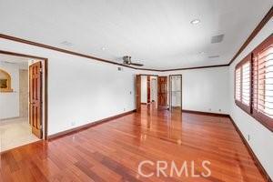 25152 Mammoth Cir, Lake Forest, CA 92630 - spare room with ornamental molding, wood finished floors, and a ceiling fan