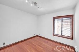 25152 Mammoth Cir, Lake Forest, CA 92630 - unfurnished room with rail lighting and wood finished floors