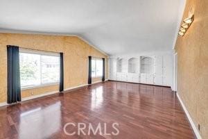 25152 Mammoth Cir, Lake Forest, CA 92630 - unfurnished living room with lofted ceiling and wood finished floors