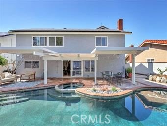 25152 Mammoth Cir, Lake Forest, CA 92630 - back of house featuring solar panels, a patio area, a pool with connected hot tub, and outdoor lounge area