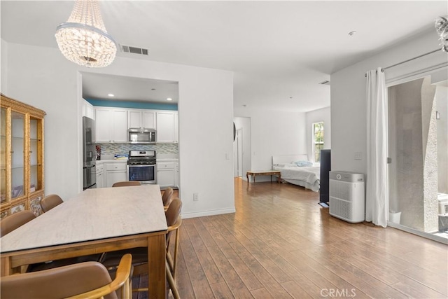 1335 Mc Fadden Dr, Fullerton, CA 92833 - dining space with a chandelier and wood finished floors