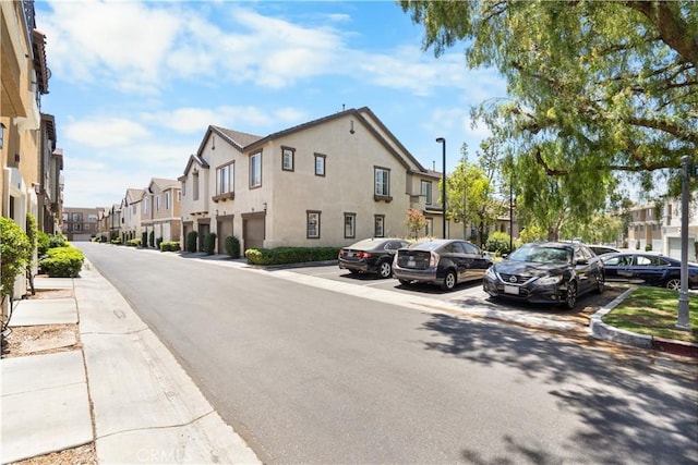 1335 Mc Fadden Dr, Fullerton, CA 92833 - view of asphalt road with a residential view, sidewalks, street lighting, and curbs