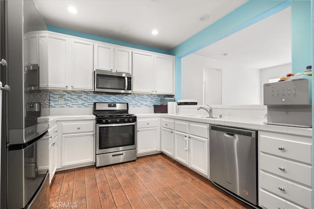 1335 Mc Fadden Dr, Fullerton, CA 92833 - kitchen featuring appliances with stainless steel finishes, tasteful backsplash, white cabinetry, and recessed lighting