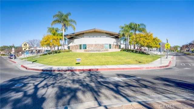 1335 Mc Fadden Dr, Fullerton, CA 92833 - view of front of house with a front lawn, stucco siding, and stone siding