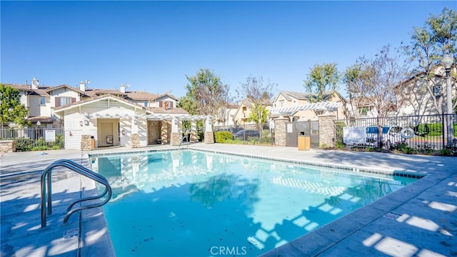 1335 Mc Fadden Dr, Fullerton, CA 92833 - community pool featuring a residential view, a pergola, and a patio area