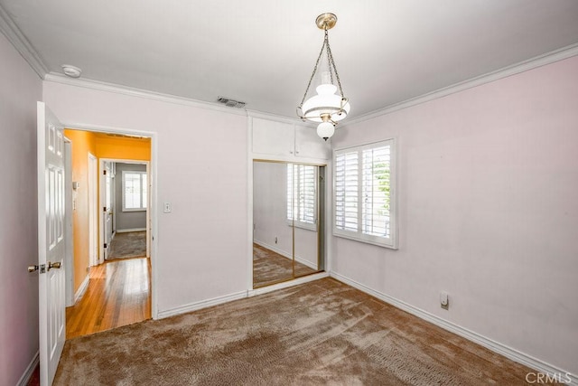 11009 Quill Ave, Sunland, CA 91040 - unfurnished bedroom with crown molding, multiple windows, carpet flooring, and a closet