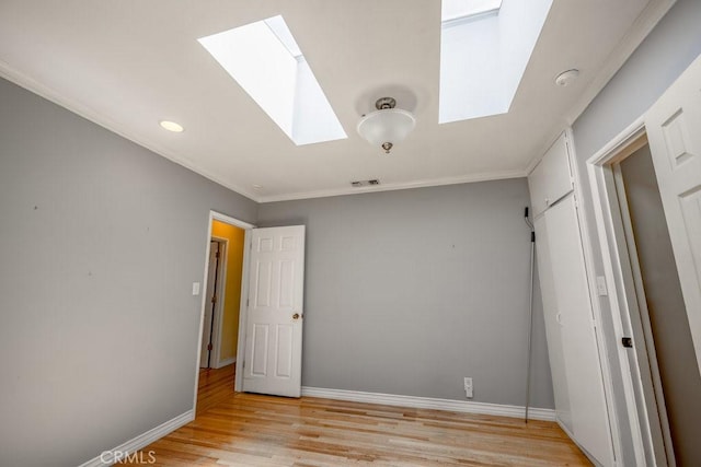 11009 Quill Ave, Sunland, CA 91040 - unfurnished bedroom with a skylight, light wood-style floors, recessed lighting, and crown molding