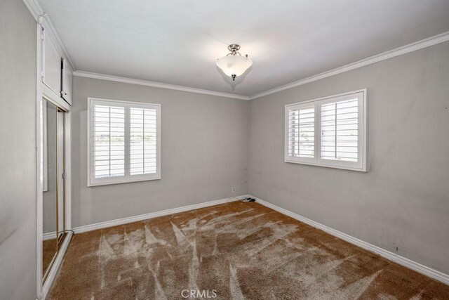 11009 Quill Ave, Sunland, CA 91040 - unfurnished bedroom featuring carpet floors, ornamental molding, and a closet