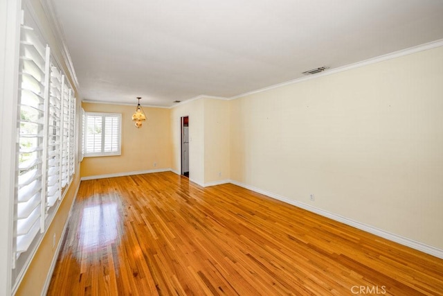 11009 Quill Ave, Sunland, CA 91040 - unfurnished room featuring light wood-type flooring, crown molding, and a chandelier