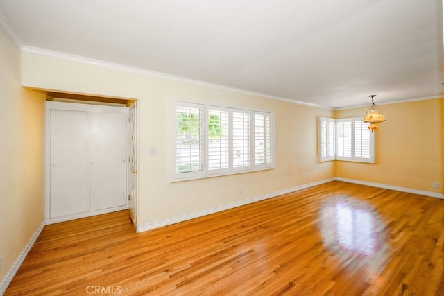 11009 Quill Ave, Sunland, CA 91040 - spare room featuring a chandelier, healthy amount of natural light, light wood-style flooring, and ornamental molding