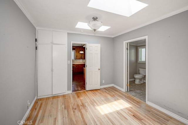 11009 Quill Ave, Sunland, CA 91040 - unfurnished bedroom with a skylight, light wood-type flooring, ensuite bathroom, and ornamental molding