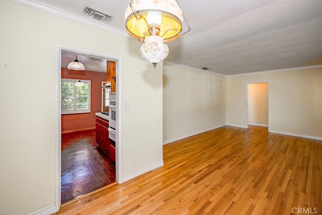11009 Quill Ave, Sunland, CA 91040 - unfurnished room with crown molding, a chandelier, and light wood-style flooring