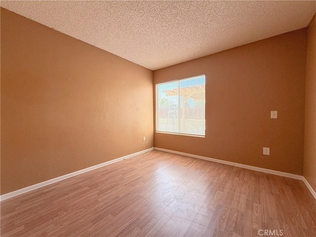 12967 Side Saddle Rd, Victorville, CA 92392 - spare room featuring light wood-style floors and a textured ceiling