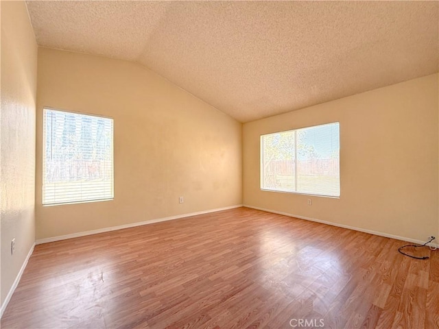 12967 Side Saddle Rd, Victorville, CA 92392 - unfurnished room featuring a textured ceiling, wood finished floors, and lofted ceiling