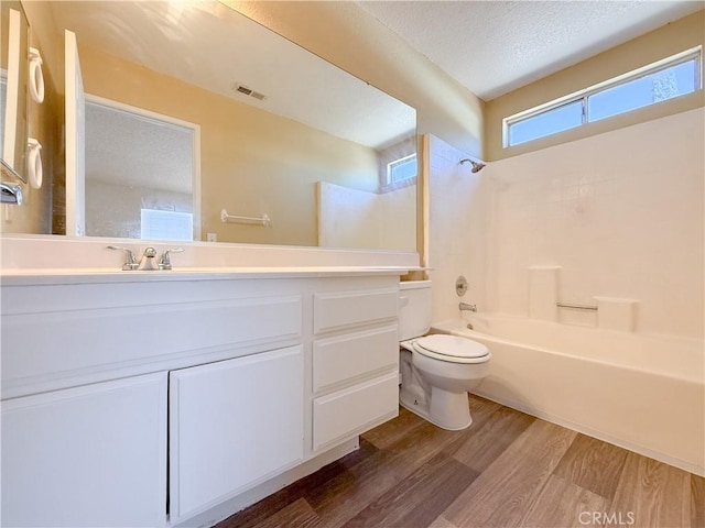 12967 Side Saddle Rd, Victorville, CA 92392 - full bathroom featuring wood finished floors, vanity, shower / bath combination, and a textured ceiling