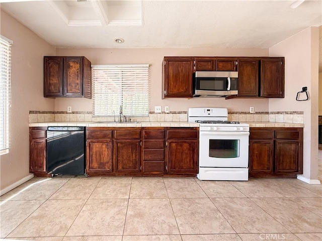 12967 Side Saddle Rd, Victorville, CA 92392 - kitchen with stainless steel microwave, white gas range, dishwasher, and healthy amount of natural light