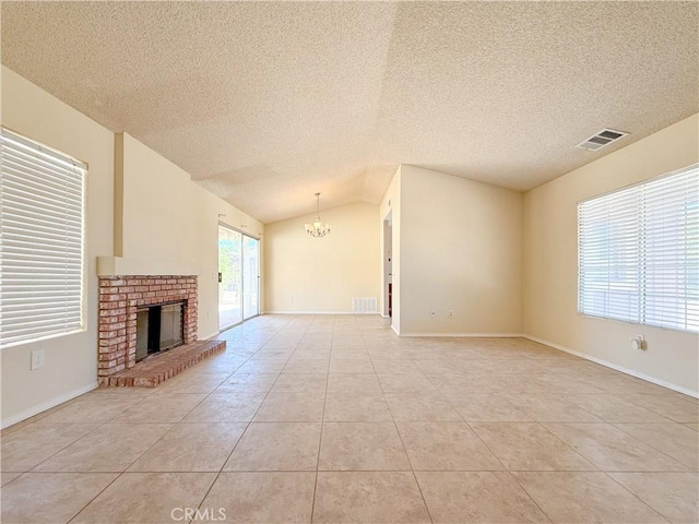 12967 Side Saddle Rd, Victorville, CA 92392 - unfurnished living room featuring a chandelier, a textured ceiling, light tile patterned floors, a brick fireplace, and vaulted ceiling
