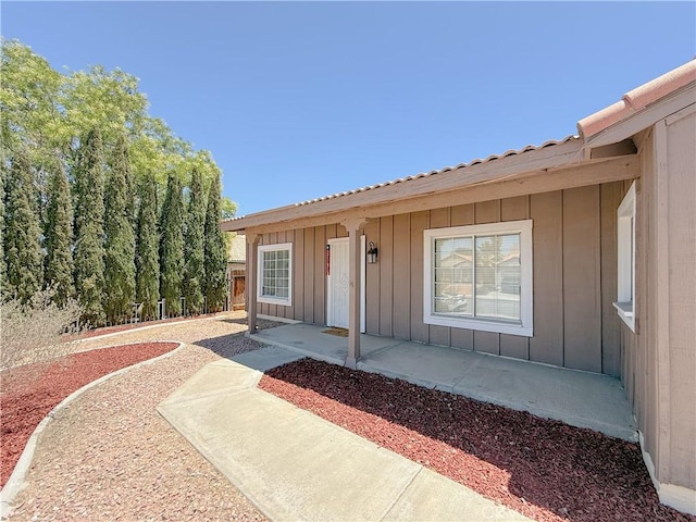 12967 Side Saddle Rd, Victorville, CA 92392 - view of exterior entry with board and batten siding and a patio