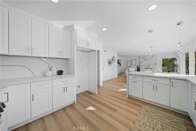 24861 Camberwell St, Laguna Hills, CA 92653 - kitchen featuring recessed lighting, white cabinets, backsplash, light wood-type flooring, and pendant lighting