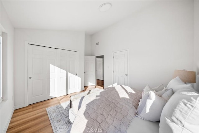 24861 Camberwell St, Laguna Hills, CA 92653 - bedroom featuring light wood-type flooring and high vaulted ceiling