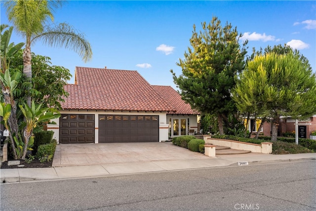 24861 Camberwell St, Laguna Hills, CA 92653 - mediterranean / spanish house with a tiled roof, driveway, an attached garage, and stucco siding