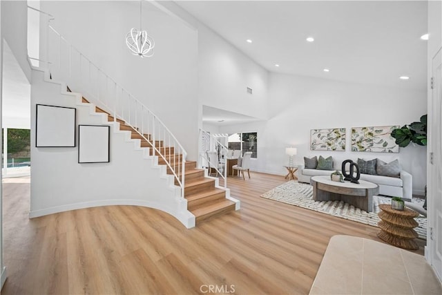 24861 Camberwell St, Laguna Hills, CA 92653 - living area featuring stairs, light wood-type flooring, recessed lighting, and high vaulted ceiling
