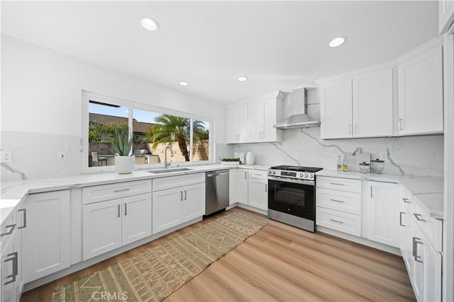 24861 Camberwell St, Laguna Hills, CA 92653 - kitchen with appliances with stainless steel finishes, wall chimney exhaust hood, recessed lighting, tasteful backsplash, and white cabinetry