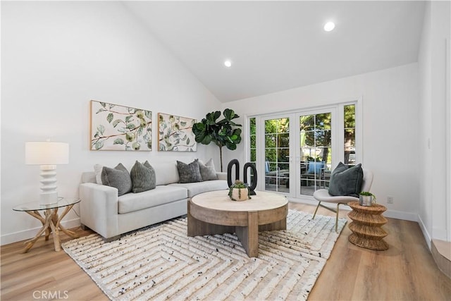 24861 Camberwell St, Laguna Hills, CA 92653 - living room featuring wood finished floors, recessed lighting, high vaulted ceiling, and french doors
