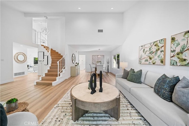 24861 Camberwell St, Laguna Hills, CA 92653 - living room with a high ceiling, light wood-style flooring, stairway, and recessed lighting