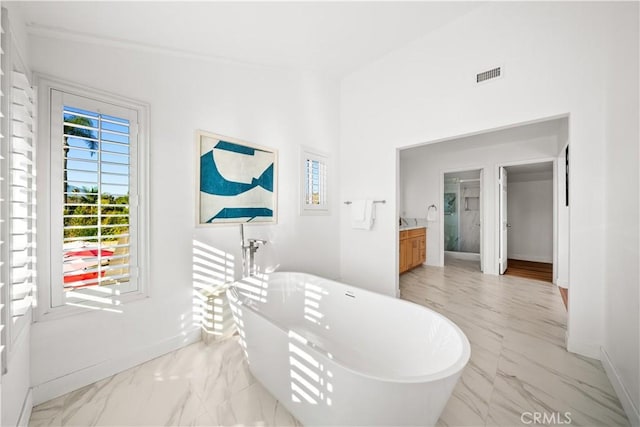 24861 Camberwell St, Laguna Hills, CA 92653 - full bathroom with marble finish floors, a freestanding tub, and vanity