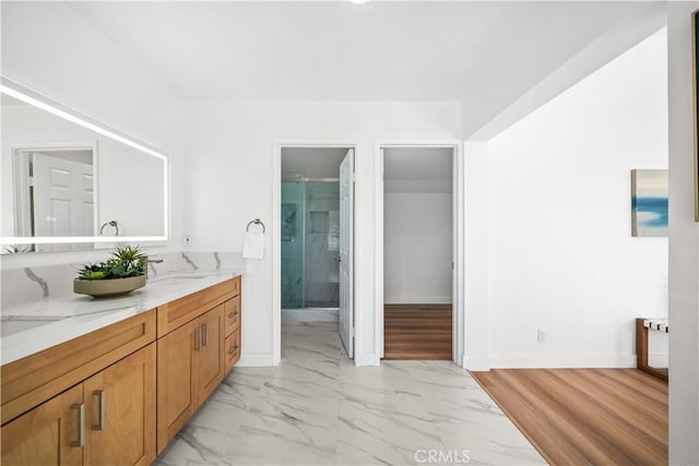 24861 Camberwell St, Laguna Hills, CA 92653 - bathroom with double vanity, marble look tiles, and a shower