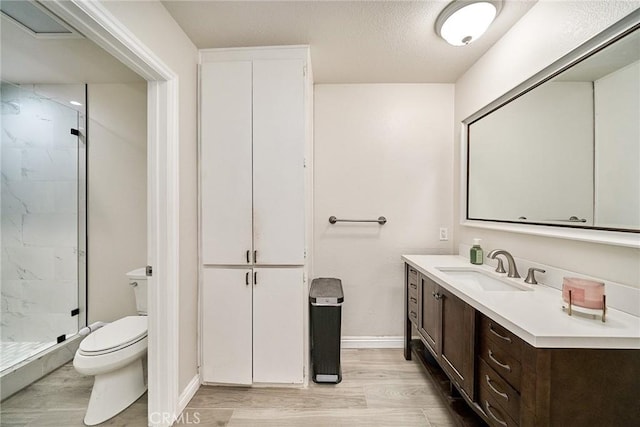 2424 S Gaffey St Unit 101, San Pedro, CA 90731 - full bathroom featuring a shower stall, vanity, wood finished floors, and a textured ceiling