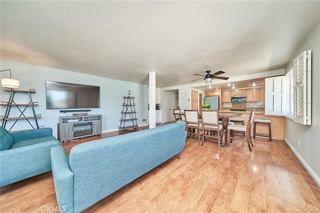 2424 S Gaffey St Unit 101, San Pedro, CA 90731 - living area featuring a ceiling fan, light wood-style flooring, and a fireplace