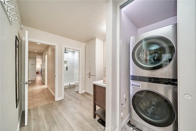 2424 S Gaffey St Unit 101, San Pedro, CA 90731 - washroom with stacked washer and clothes dryer and light wood-style flooring