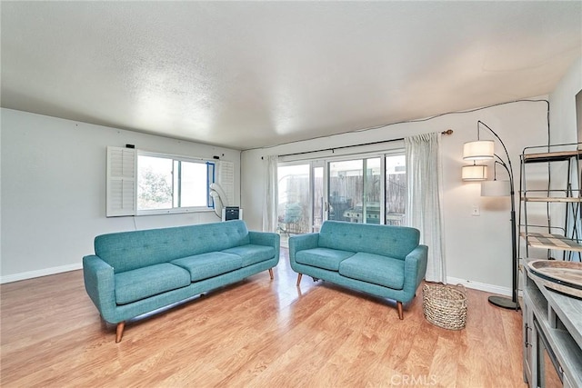 2424 S Gaffey St Unit 101, San Pedro, CA 90731 - living area featuring baseboards and light wood-style floors