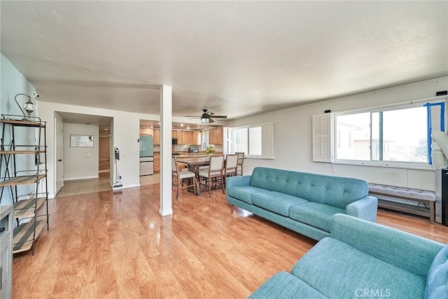 2424 S Gaffey St Unit 101, San Pedro, CA 90731 - living area featuring a ceiling fan and light wood finished floors