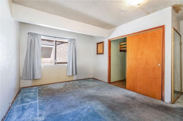 2439 California St, Walnut Park, CA 90255 - unfurnished bedroom with carpet flooring, a textured ceiling, and a closet