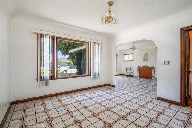 2439 California St, Walnut Park, CA 90255 - spare room featuring arched walkways, light floors, and a chandelier