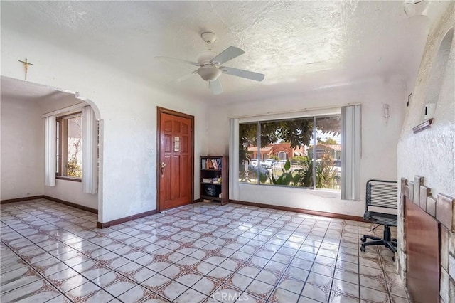 2439 California St, Walnut Park, CA 90255 - home office featuring arched walkways, ceiling fan, and a textured ceiling