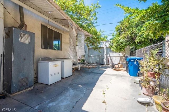 2439 California St, Walnut Park, CA 90255 - view of patio featuring washing machine and dryer and an outbuilding