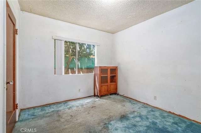 2439 California St, Walnut Park, CA 90255 - carpeted empty room featuring a textured ceiling and baseboards