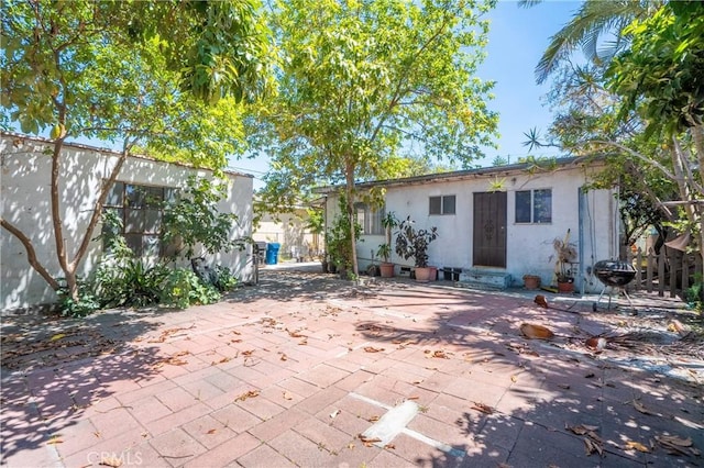 2439 California St, Walnut Park, CA 90255 - back of house with stucco siding and a patio area