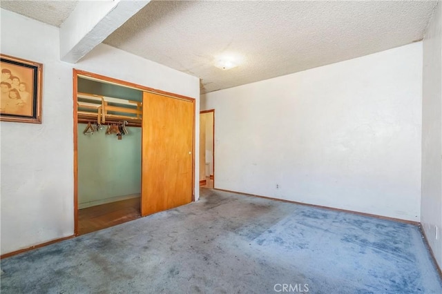 2439 California St, Walnut Park, CA 90255 - unfurnished bedroom with carpet, a textured ceiling, and a closet